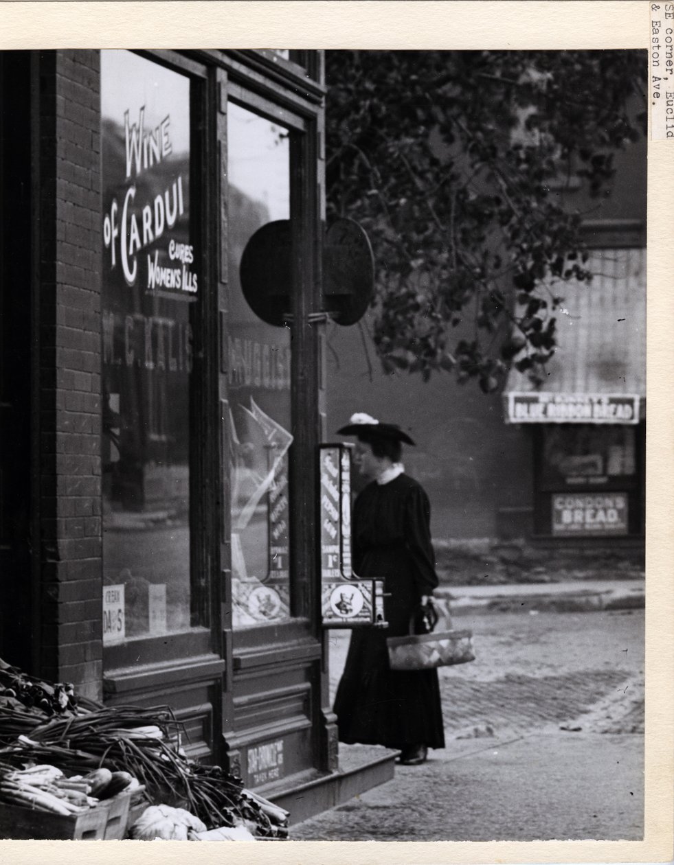Woman Holding a Basket in Front of W. C. Kalis Drugstore by Charles Clement Holt