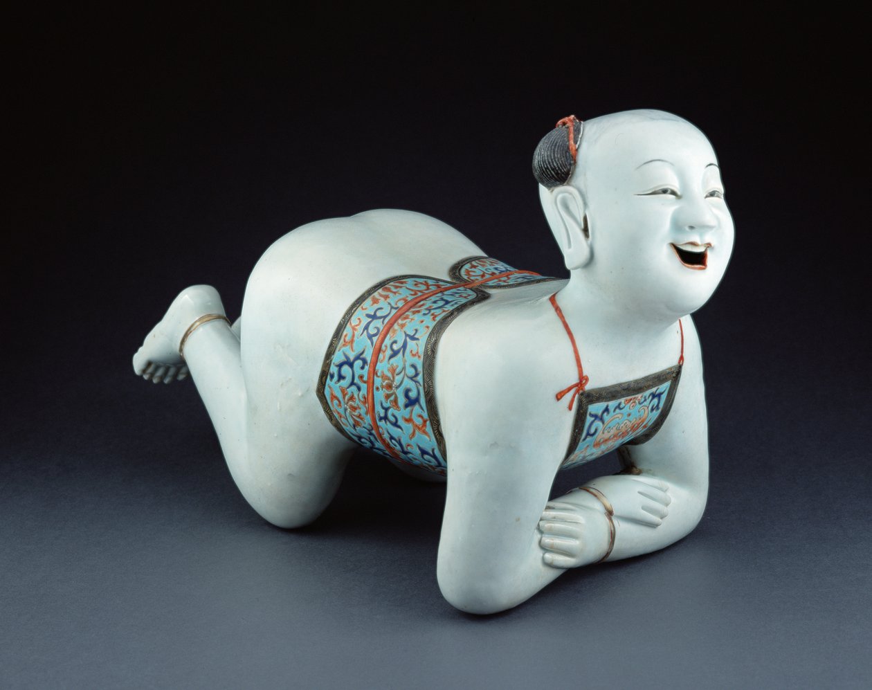 Chinese Porcelain Pillow in the Form of a Semi-Naked Boy by Chinese School