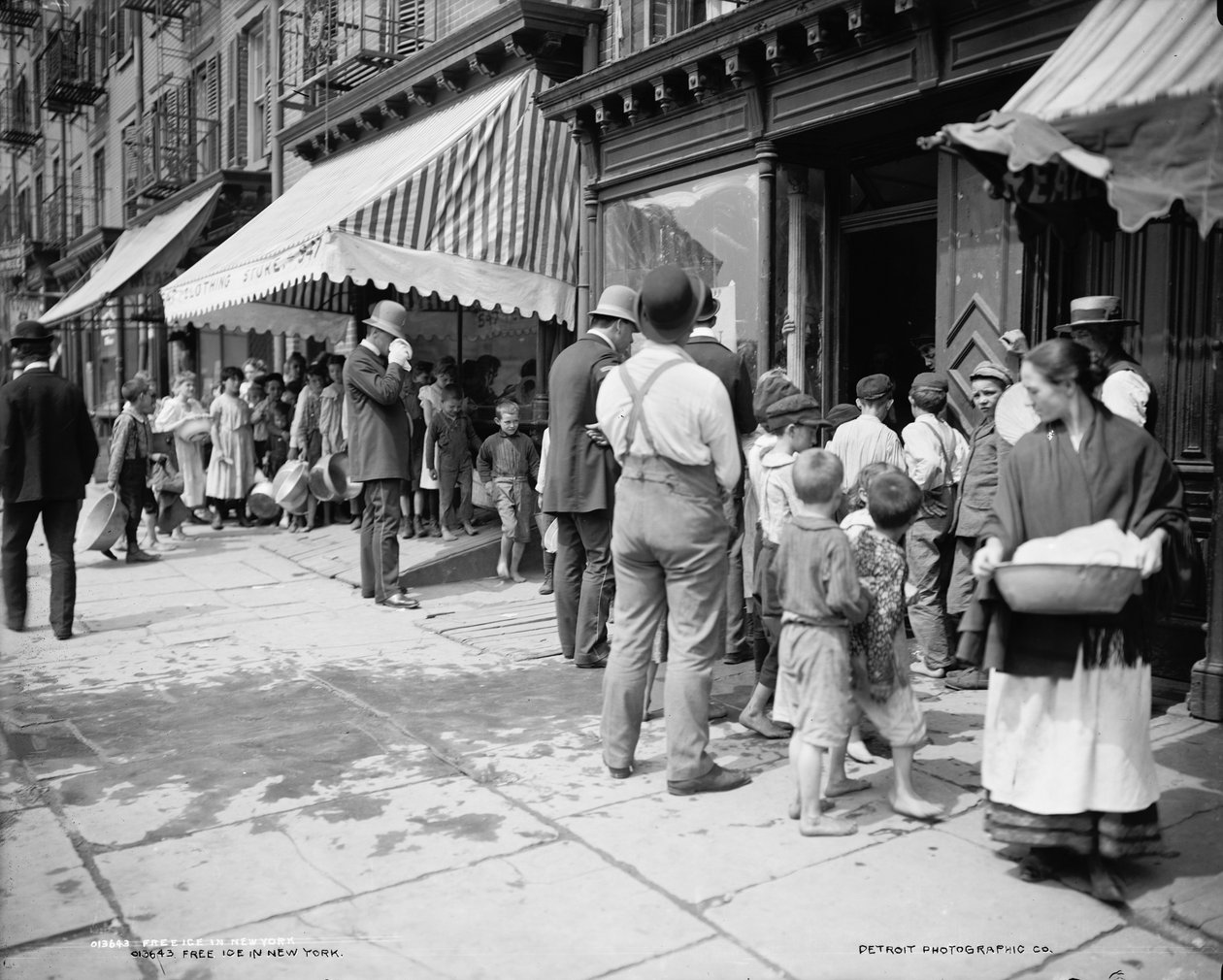 Giving out free ice in Mulberry Street, New York, c.1900 by Company Byron