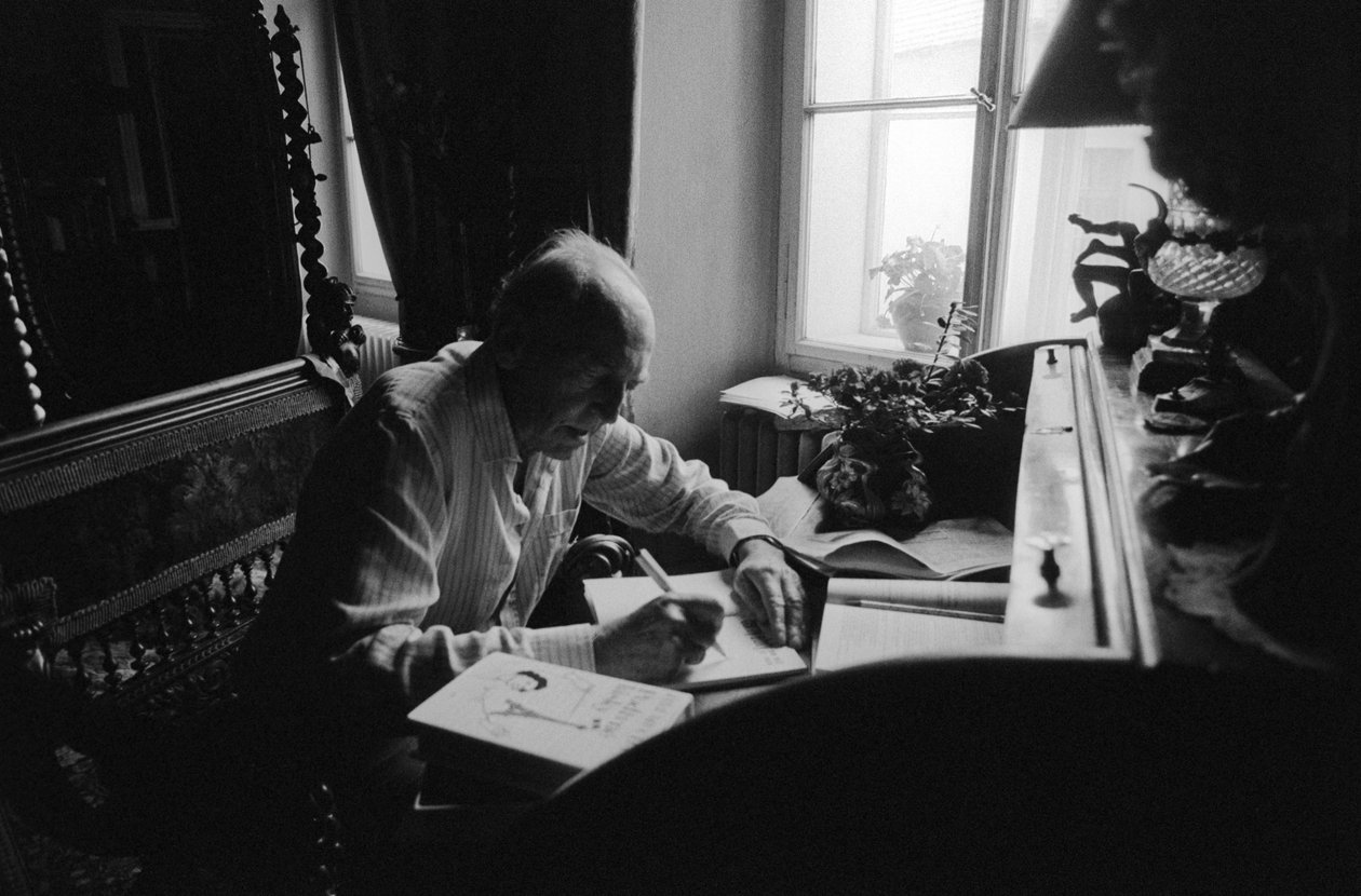 Jiri Mucha Sitting at His Desk in His House in Hradcany, Prague by Czech Photographer