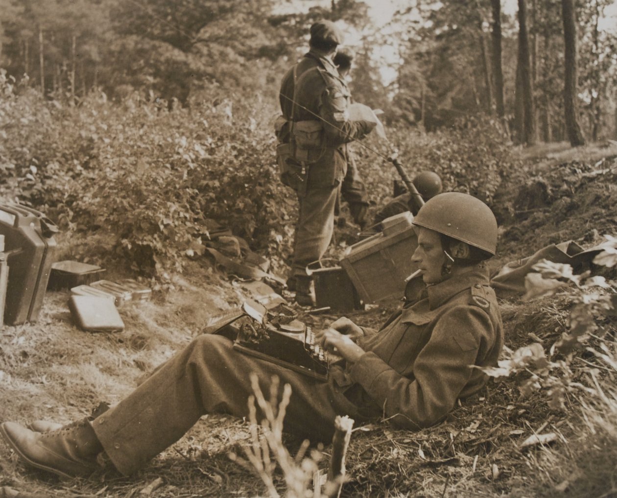 War correspondent Alan Wood typing out a despatch by D.M. Sgt. Smith