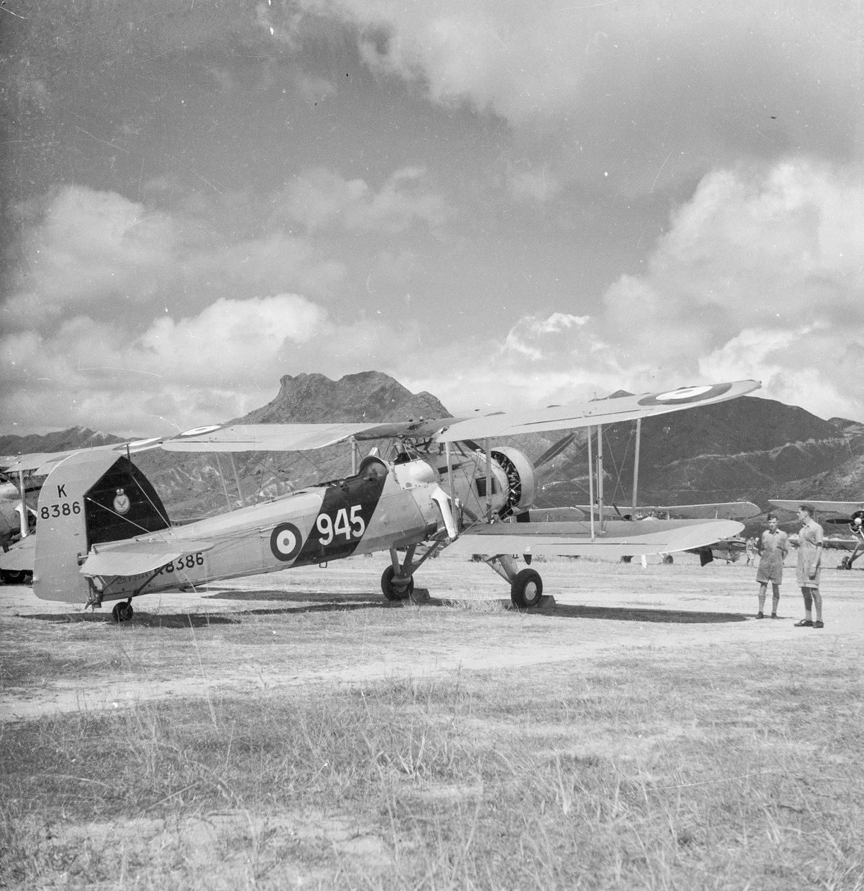 Fairey Swordfish I torpedo bomber reconnaissance biplane aircraft K8386, code 945, of 824 Squadron Fleet Air Arm, on Kai Tak airfield, Hong Kong by David Watkin Waters