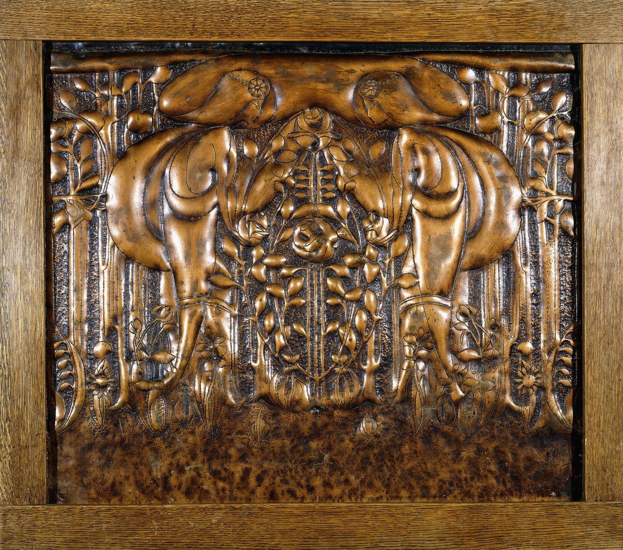 A decorative lead panel moulded in high relief, depicting two facing stylised maidens by Donald McKay Stoddart