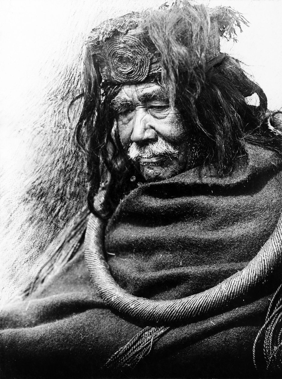 The Hamatsa, Nakoaktok c. 1910 Half-length portrait of Nakoaktok man, facing left, wearing cedar root ceremonial loop. by Edward Sheriff Curtis