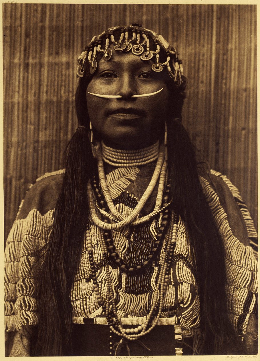 Wishham girl. This girl is dressed in a heavy suede dress adorned with pearls. The indispensable ornamental attribute of a well-born person was the dental shell in the nasal septum. The headdress is made of shells, shells and junk beads as well as Chinese by Edward Sheriff Curtis