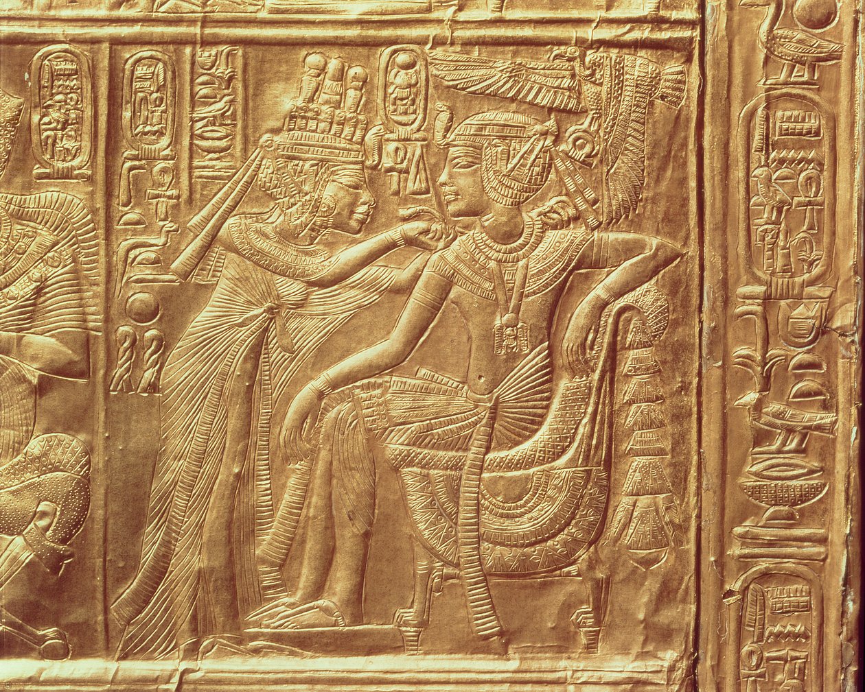 Detail from the little shrine of Tutankhamun depicting the Queen fastening a necklace round the king