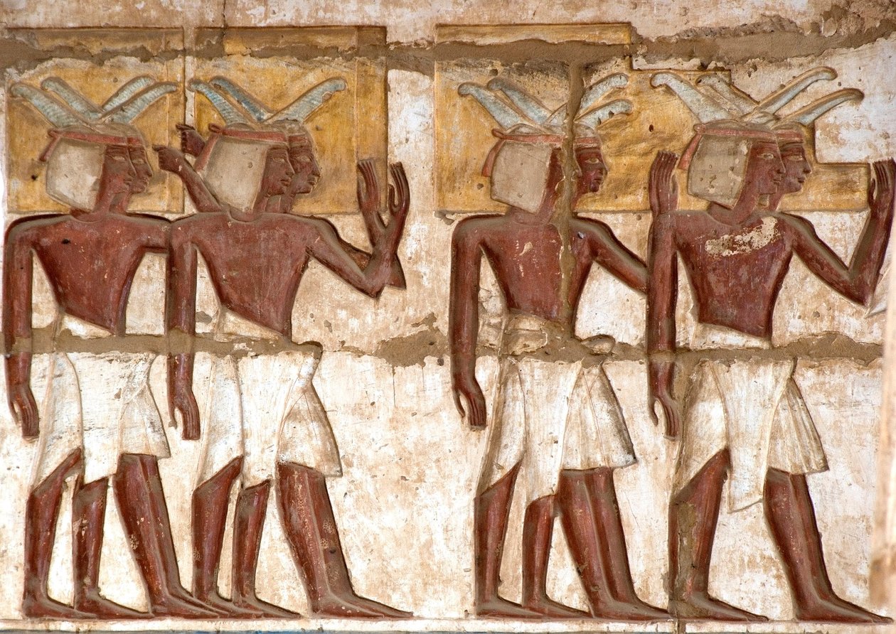 Egyptian antiquity: first court, detail of painted reliefs representing a group of Nubians bringing offerings to the pharaoh. Funeral Temple of Ramses III by Egyptian 20th Dynasty