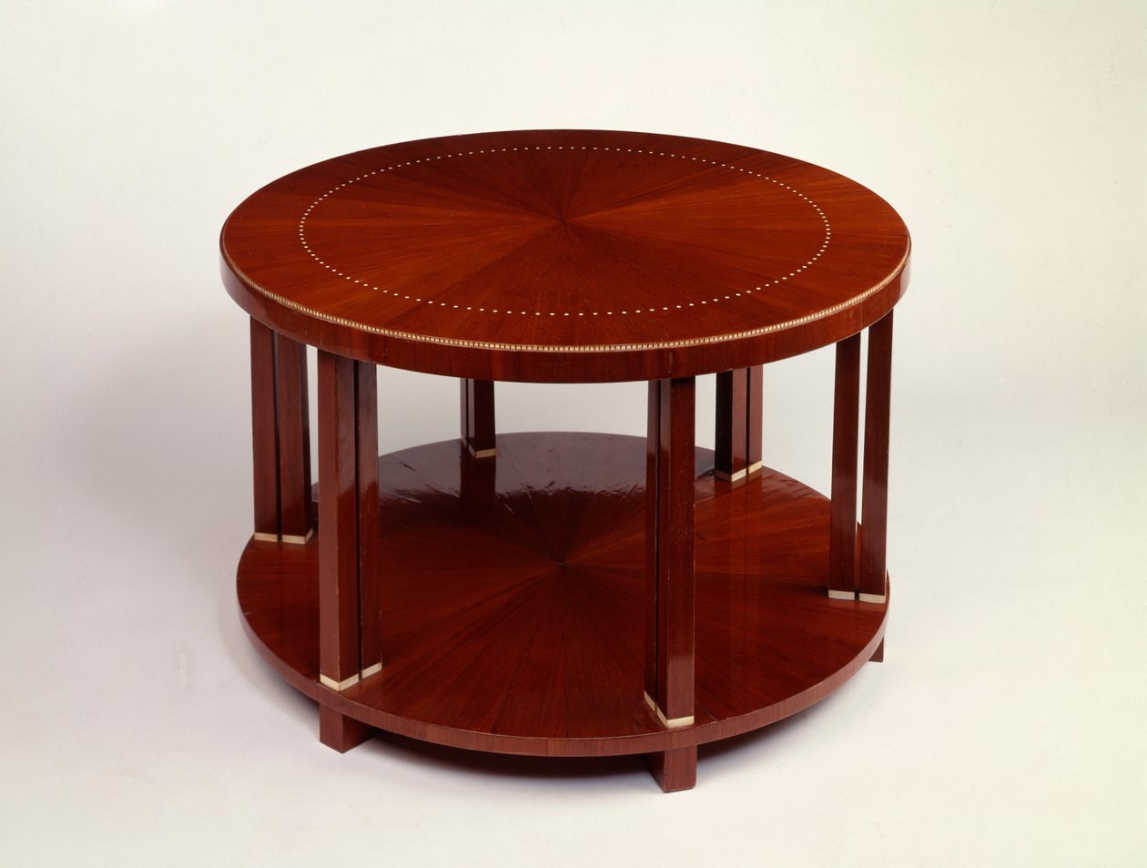 A low round twin level table with rosewood veneer, inlaid with ivory
