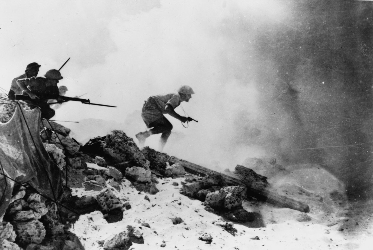 A British officer armed with a revolver leading his men forward with fixed bayonets, one of seven official photographs relating to the 2nd Battle of El Alamein, 1942 by English Photographer