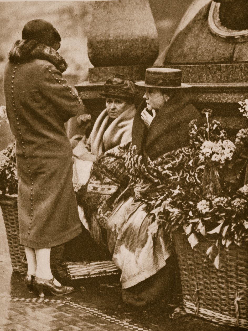 Flower sellers huddle and chat at Piccadilly Circus by English Photographer