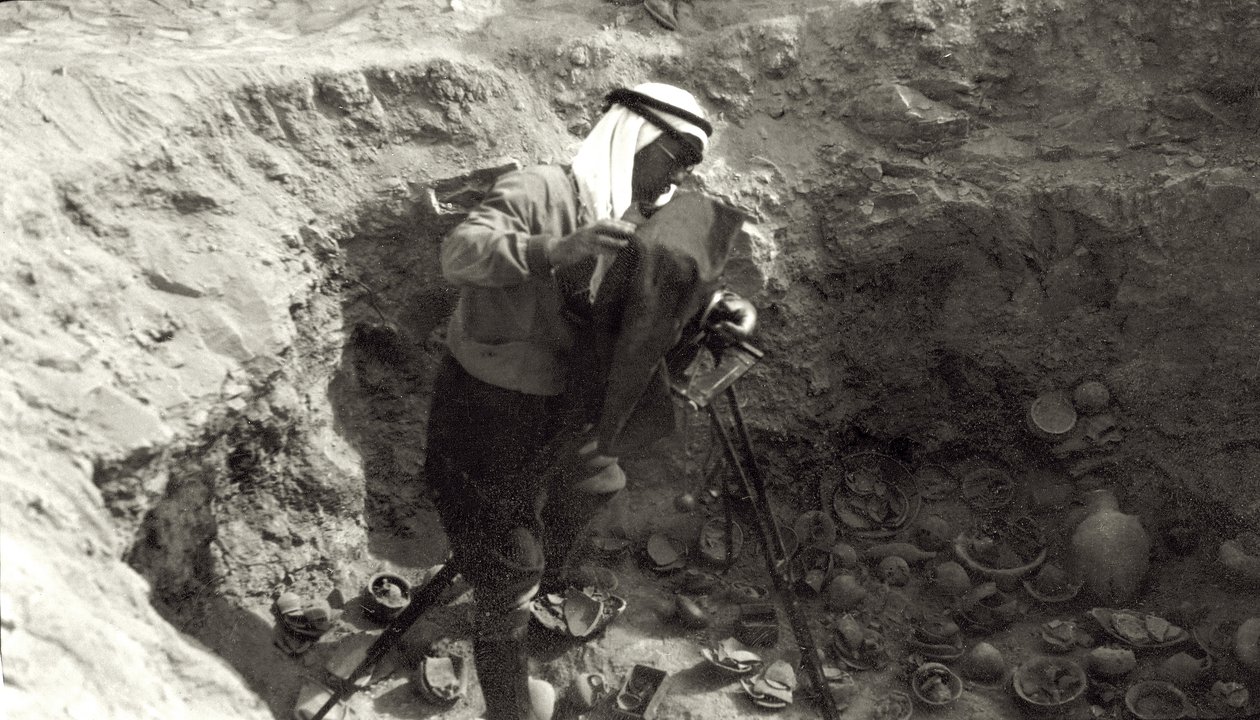 Professor John Garstang photographing broken pottery in situ at the Jericho excavations by English Photographer