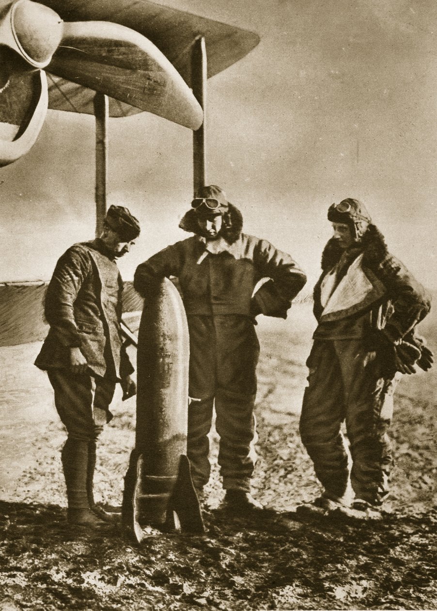 The Sowers: British airmen contemplating a bomb which will scatter death among the foe by English Photographer