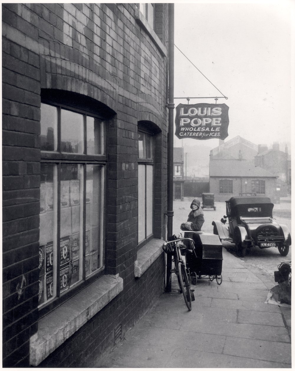 Woman with a Perambulator Outside Louis Popes Premises, Lady Lane, Leeds, 1931 by English Photographer