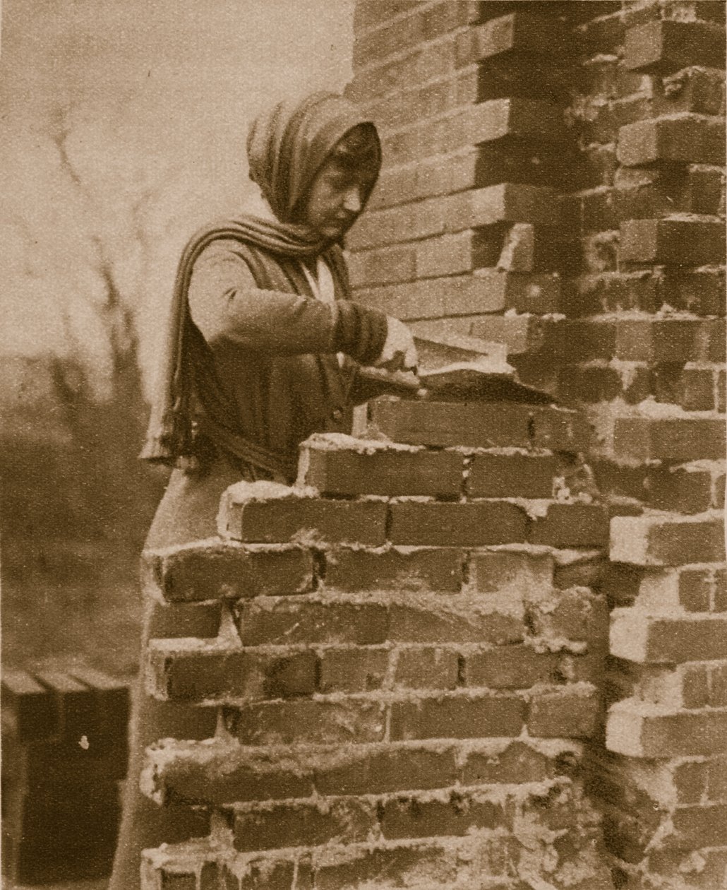 Women work force laying a brick wall by English Photographer