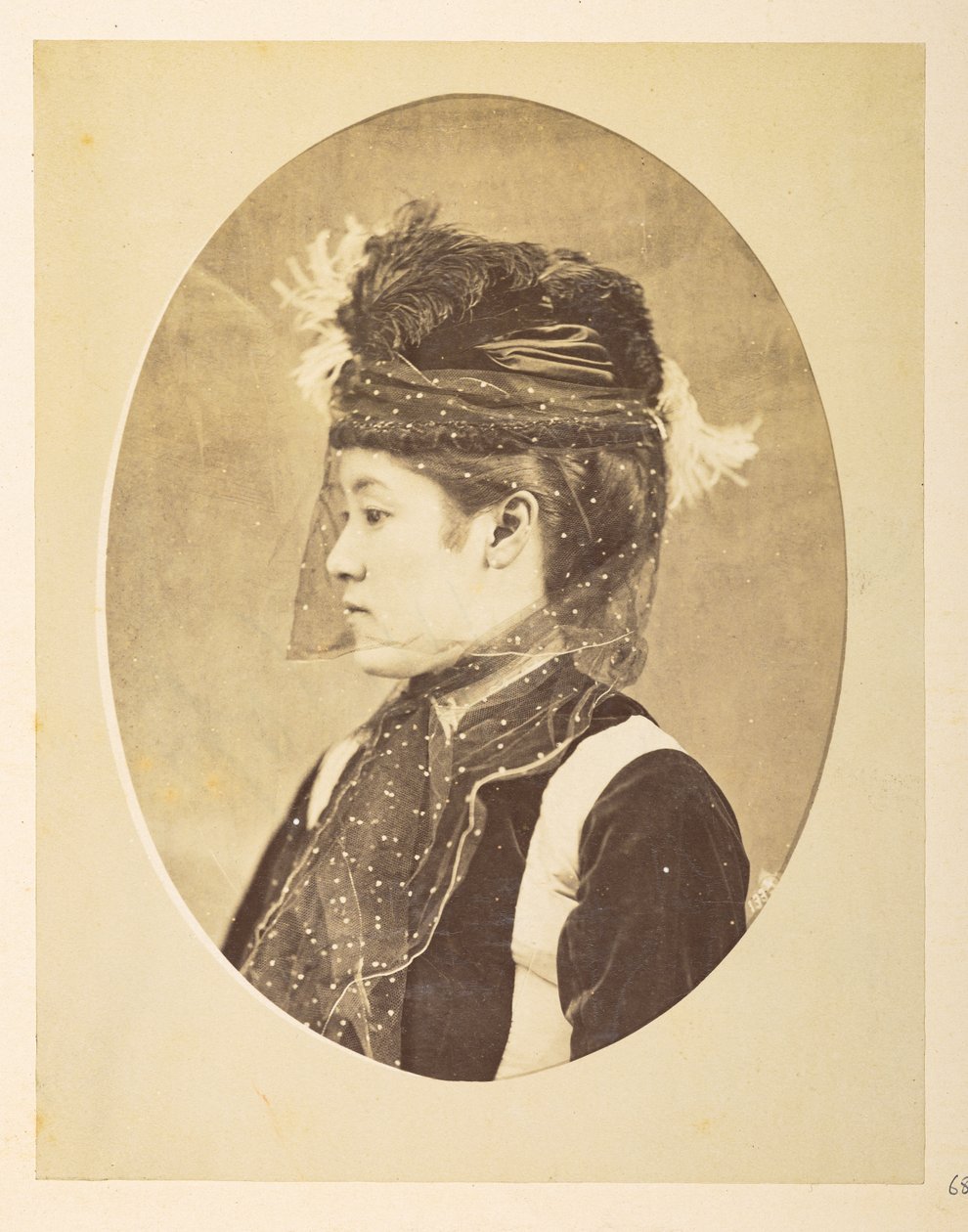 Japanese woman in European dress, Oval image; head-and-shoulders left profile portrait by English Photographer