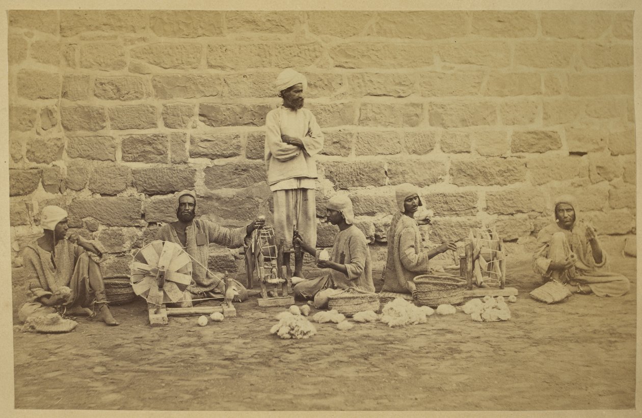 Male prisoners winding cotton on spinning wheels in Karachi Prison by English Photographer