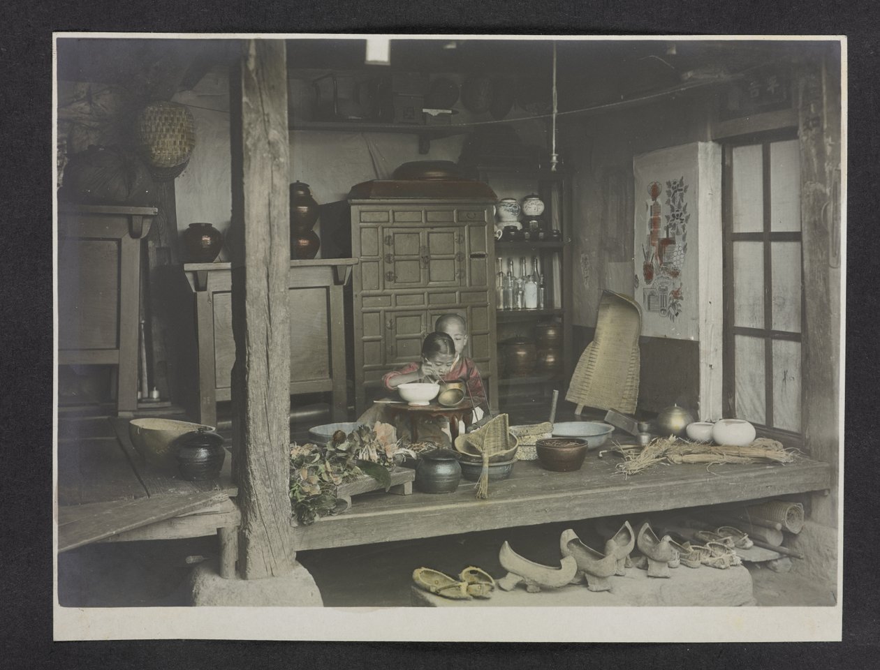 Two Children Eating, Inside a House, Photograph Album of Korea by English Photographer