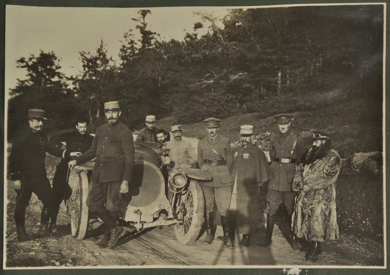 William Lawrence Bragg and Harold Roper as part of a group with a motorcar on a mountain road, Vosges, 1915 by English Photographer