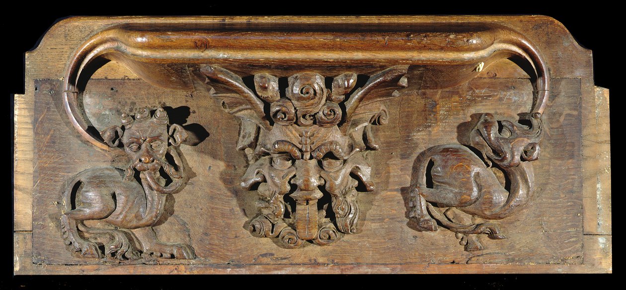 A misericord depicting three human faces flanked by monsters, New College Chapel, Oxford, late 14th century by English School