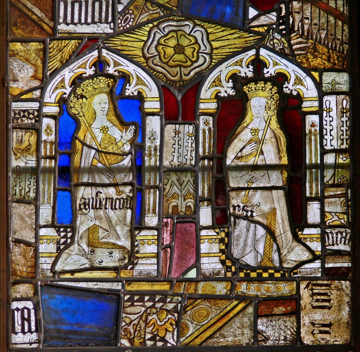 A panel in the east window depicting the Cardinal Virtues: Mercy (Misericordia) and Peace (Pax) and a white rose by English School