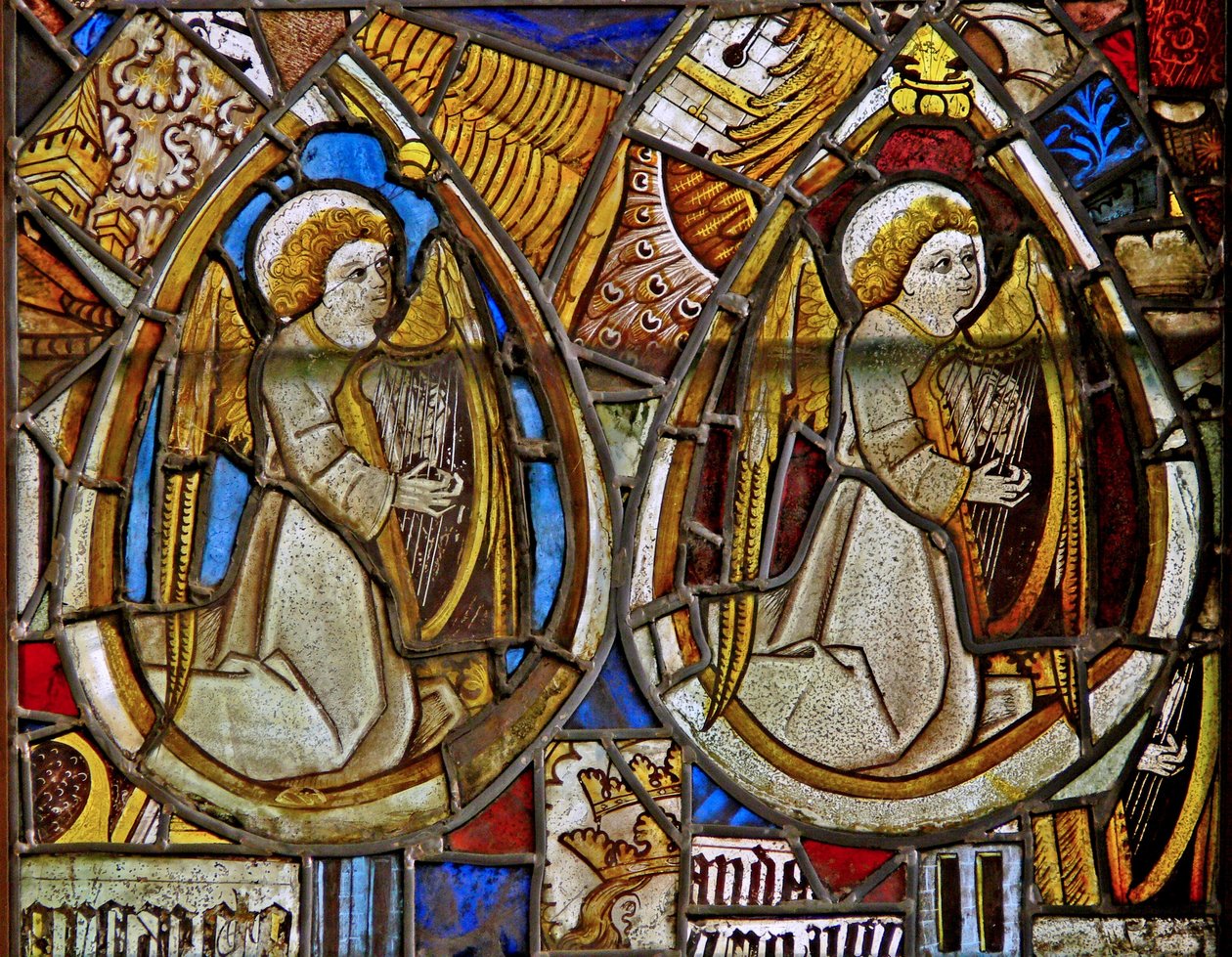 A panel in the east window depicting two musician angels with harps amid fragments by English School