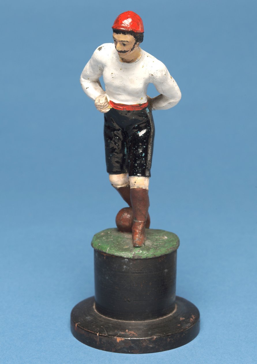 Footballer with the ball at his feet by English School