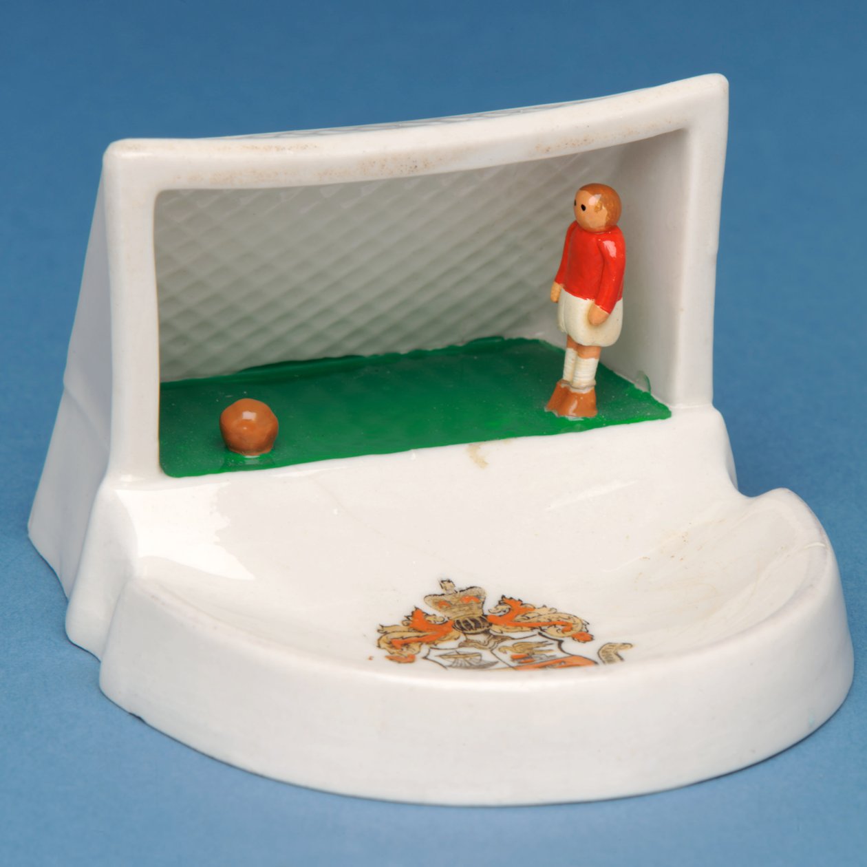 Rare armorial souvenir of Douglas, Isle of Man, showing a goalkeeper in his goal (ceramic) by English School