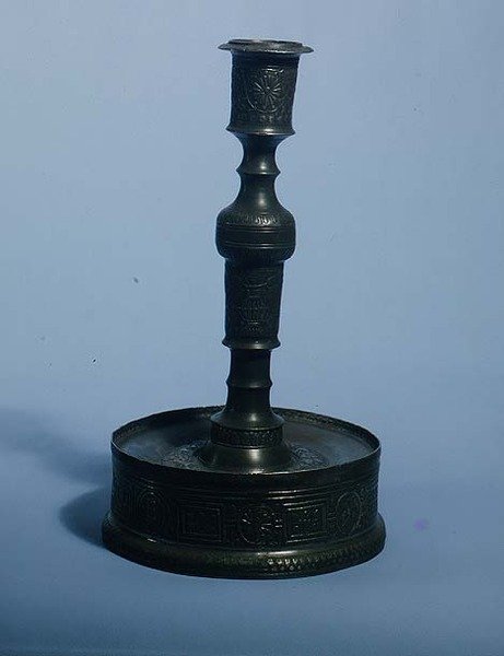 William Grainger candlestick with relief cast decoration, dated 1616 by English School