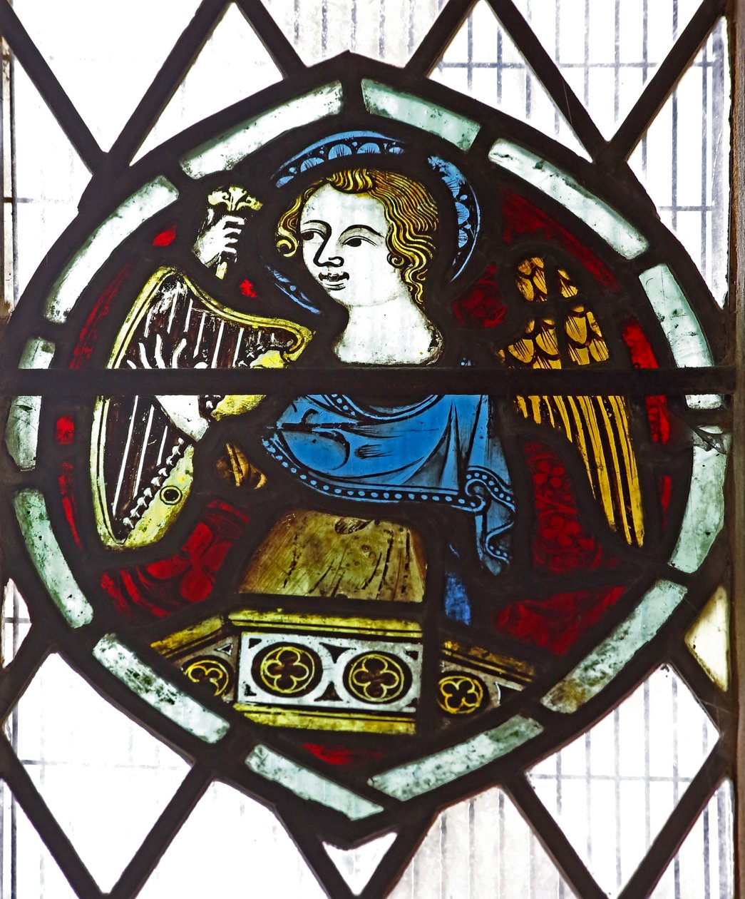 Window n6 depicting an angel with a harp by English School