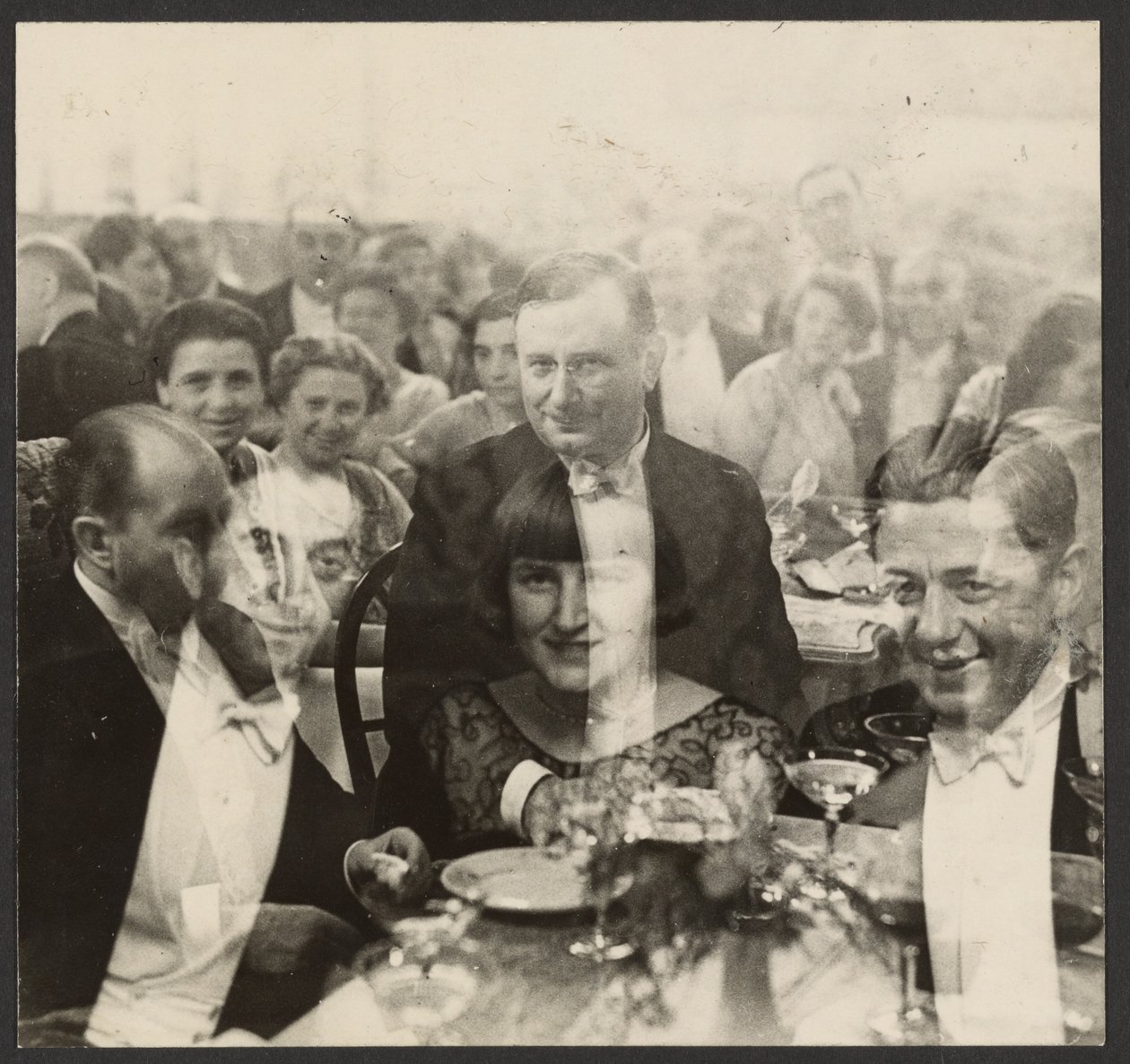 Double Exposure of a Group of People at a Banquet by Erich Salomon