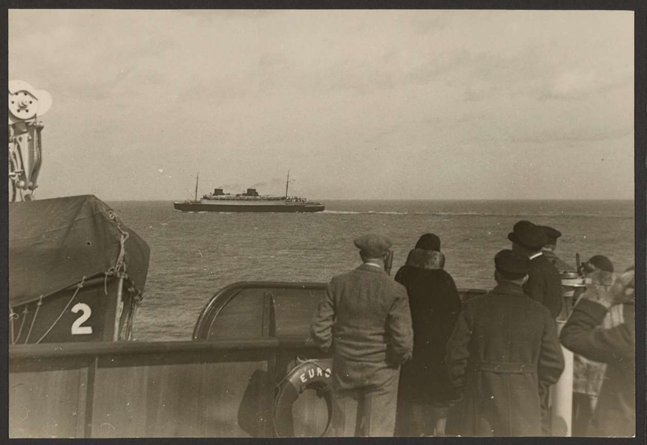 Group of People on the Deck of a Ship Watching Another Ship Sailing Past in the Distance by Erich Salomon