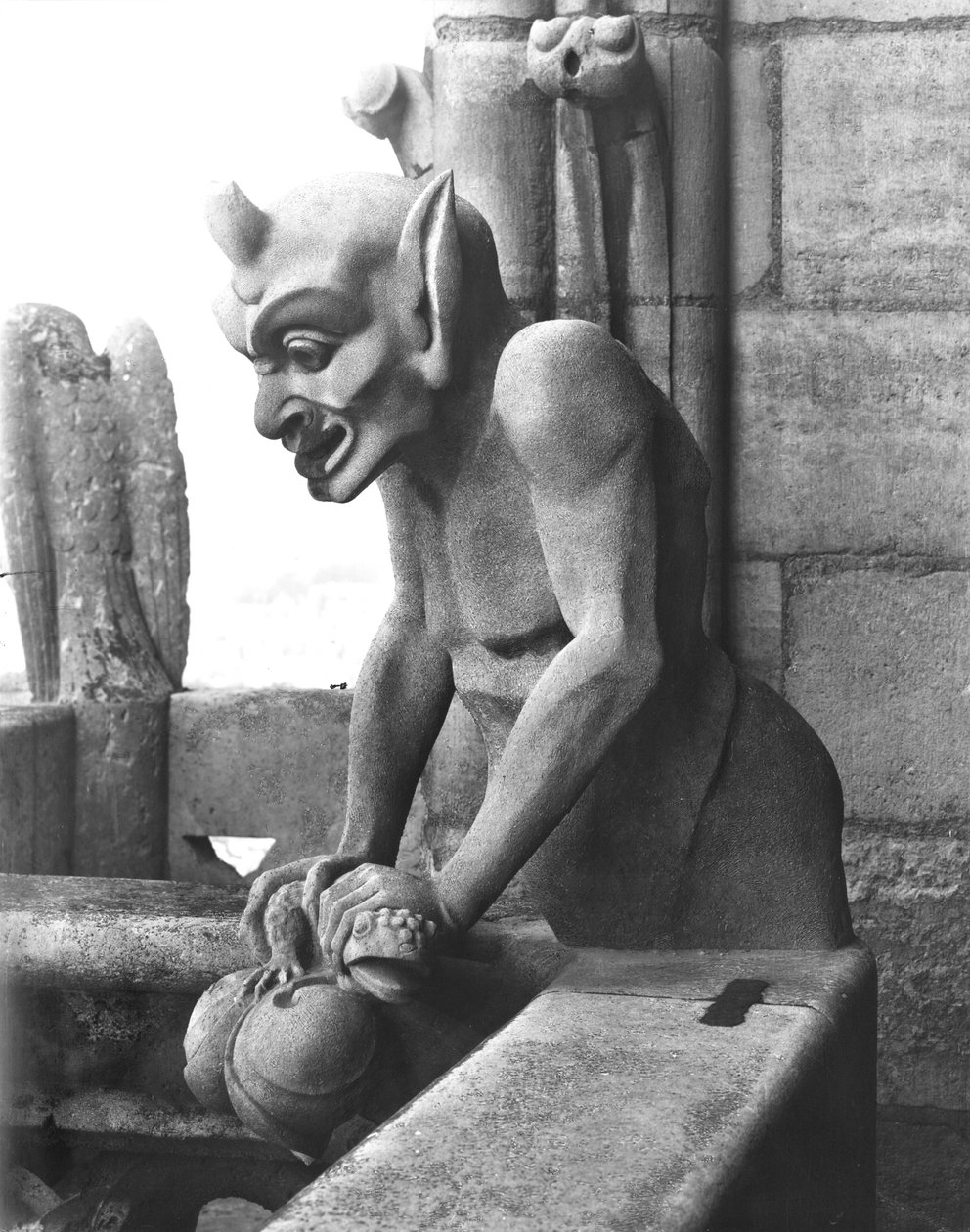 Gargoyle from the balustrade of the Grande Galerie, devil holding a toad, replica of a 12th century original by Eugene Emmanuel Viollet le Duc