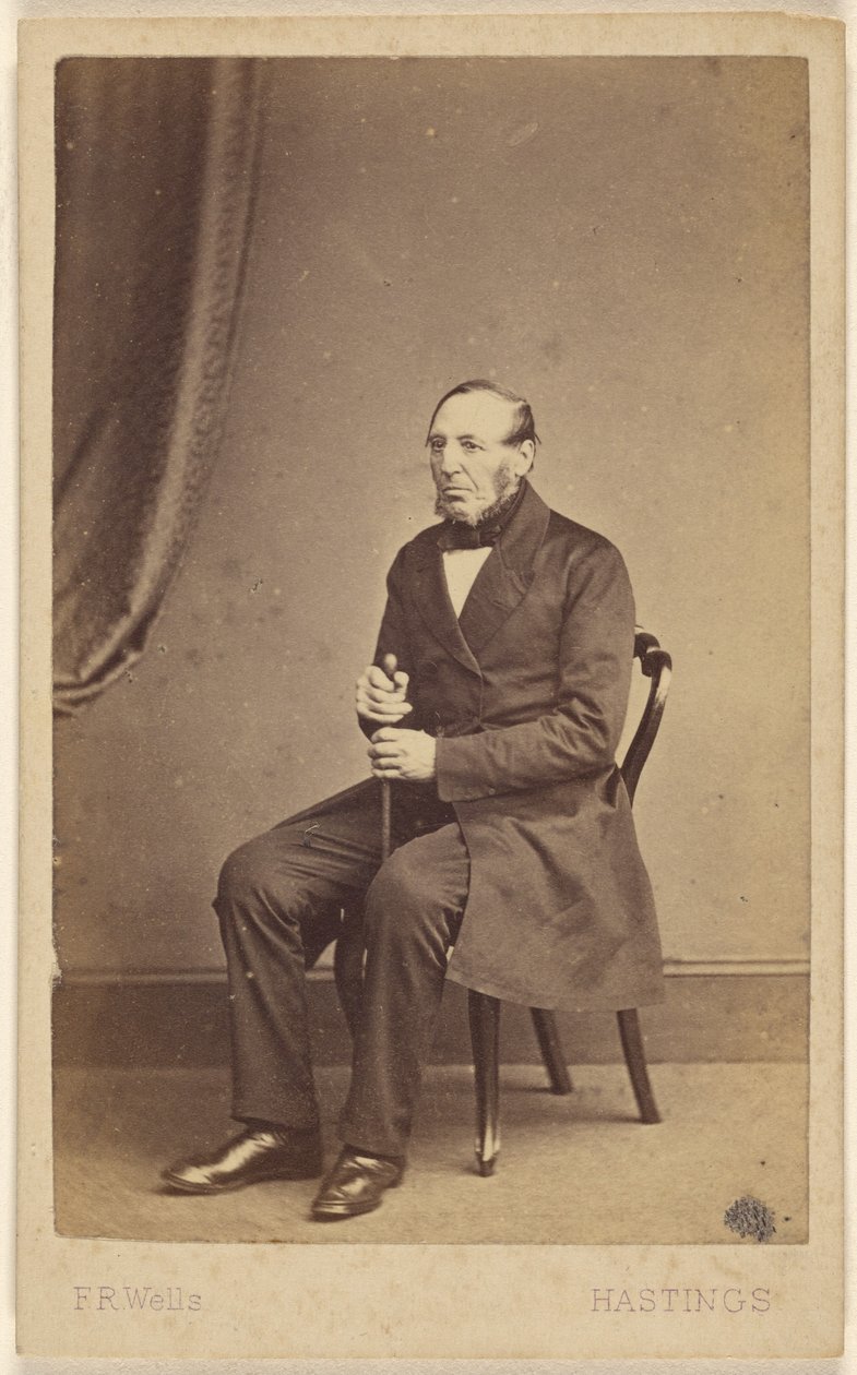 Unidentified elderly man with beard sans moustache, seated by F.R. Wells
