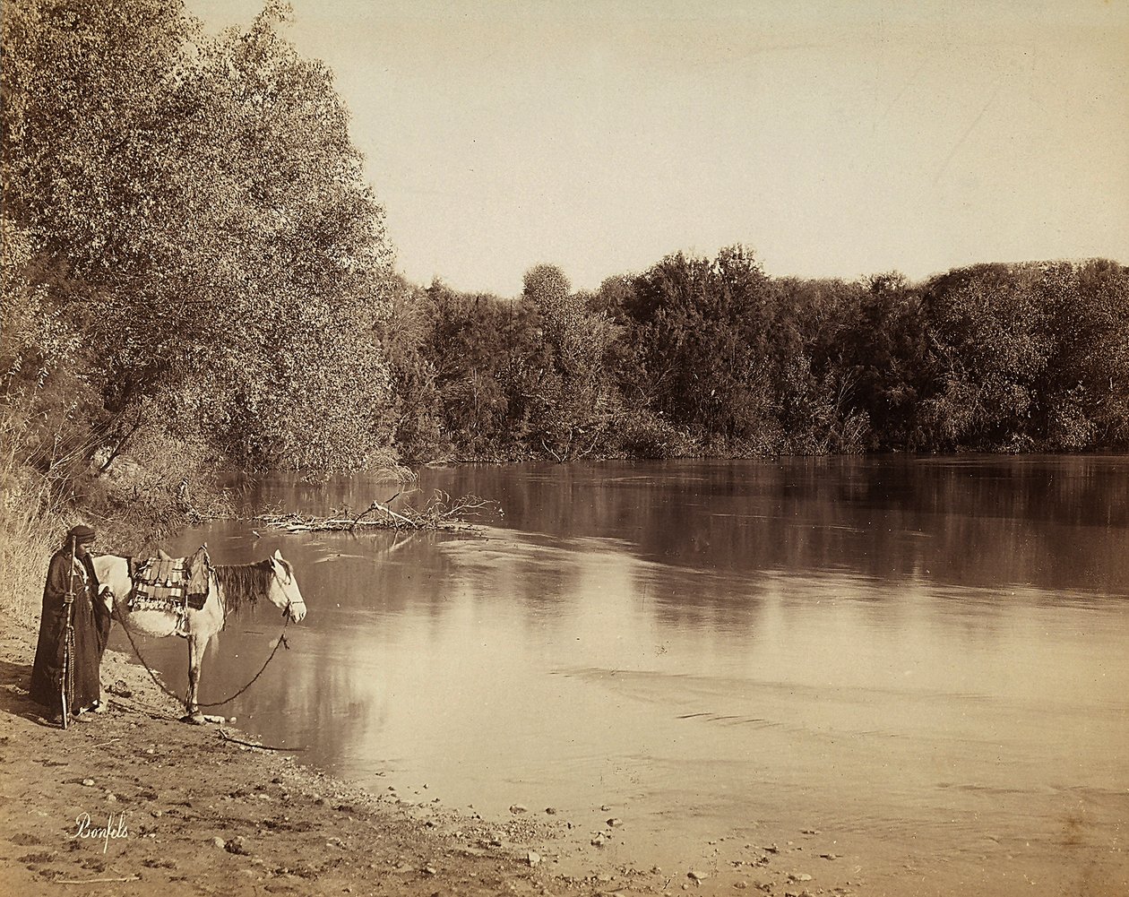 A Man in Traditional Dress with His Horse, in Front of a Lake in Egypt by Félix Bonfils