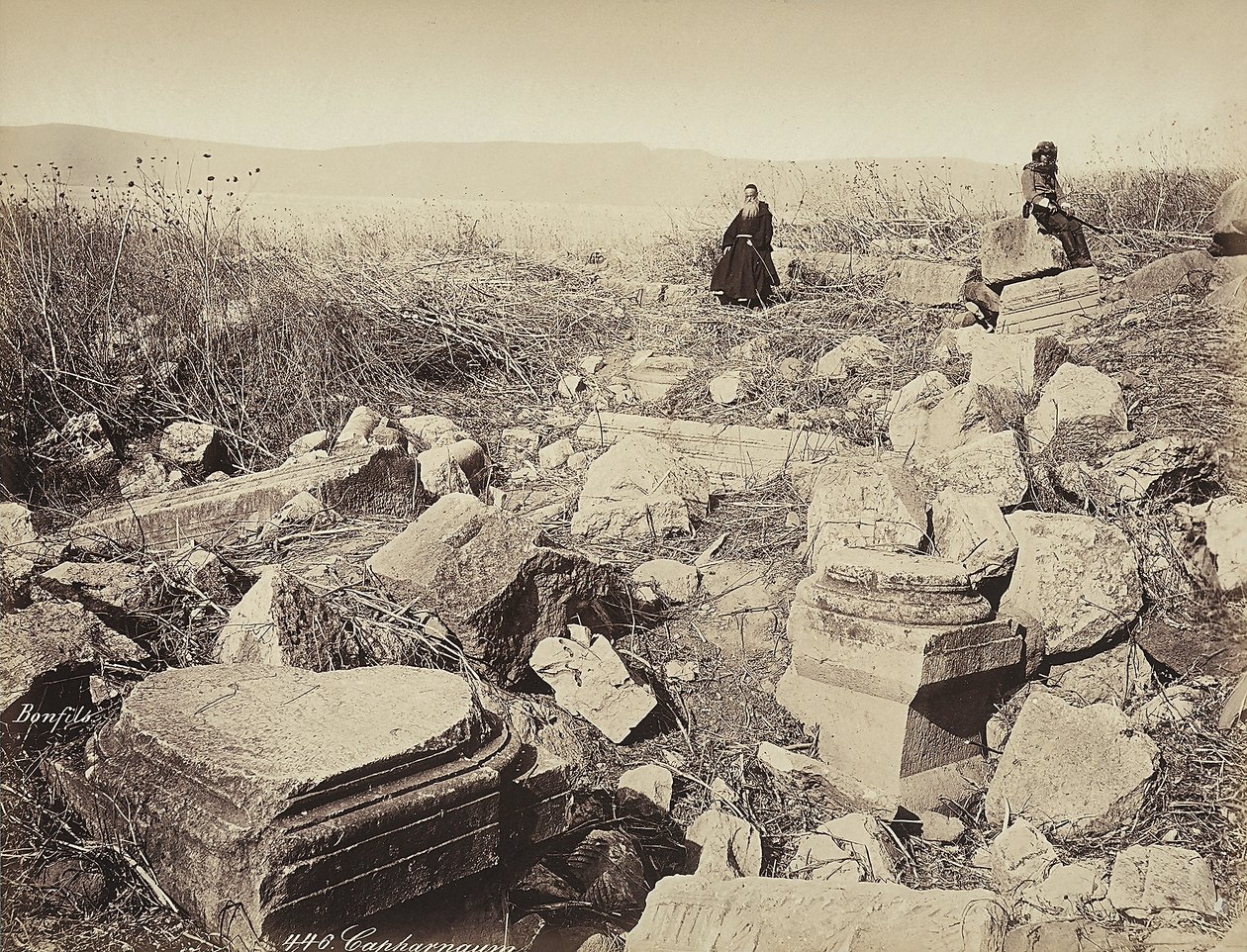 A monk and a man with a gun pose, sitting on some ruins, near Capharnaum by Félix Bonfils