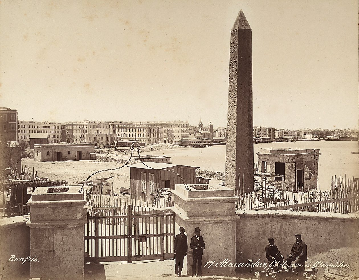 Alexandria, Egypt: the Obelisk of Cleopatra, with four men posing for the photograph by Félix Bonfils