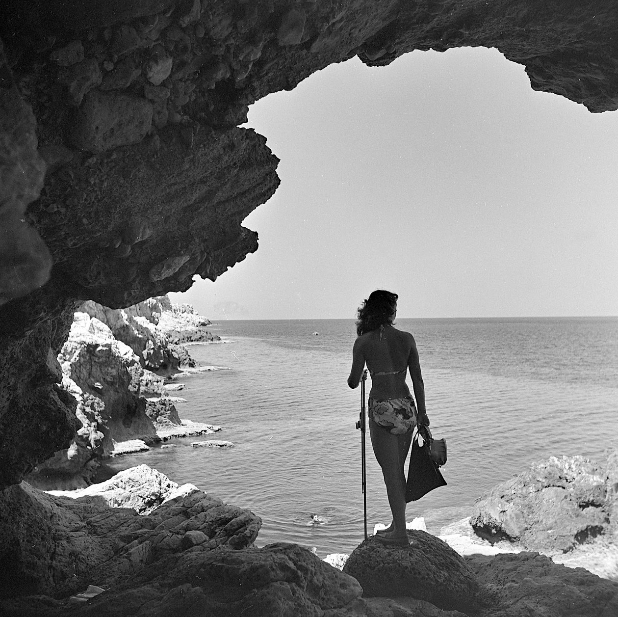 Bather on the Cliff Looking Down at the Sea near the Village of Aspra, near Palermo, Sicily, ca 1950 by Fosco Maraini
