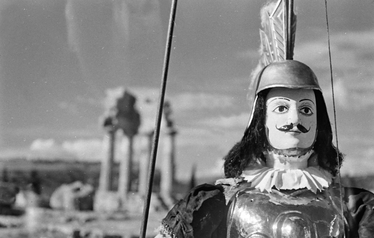 Sicilian Puppet. In the Background the Temple of Castor and Pollux in the Valley of the Temples in Agrigento by Fosco Maraini