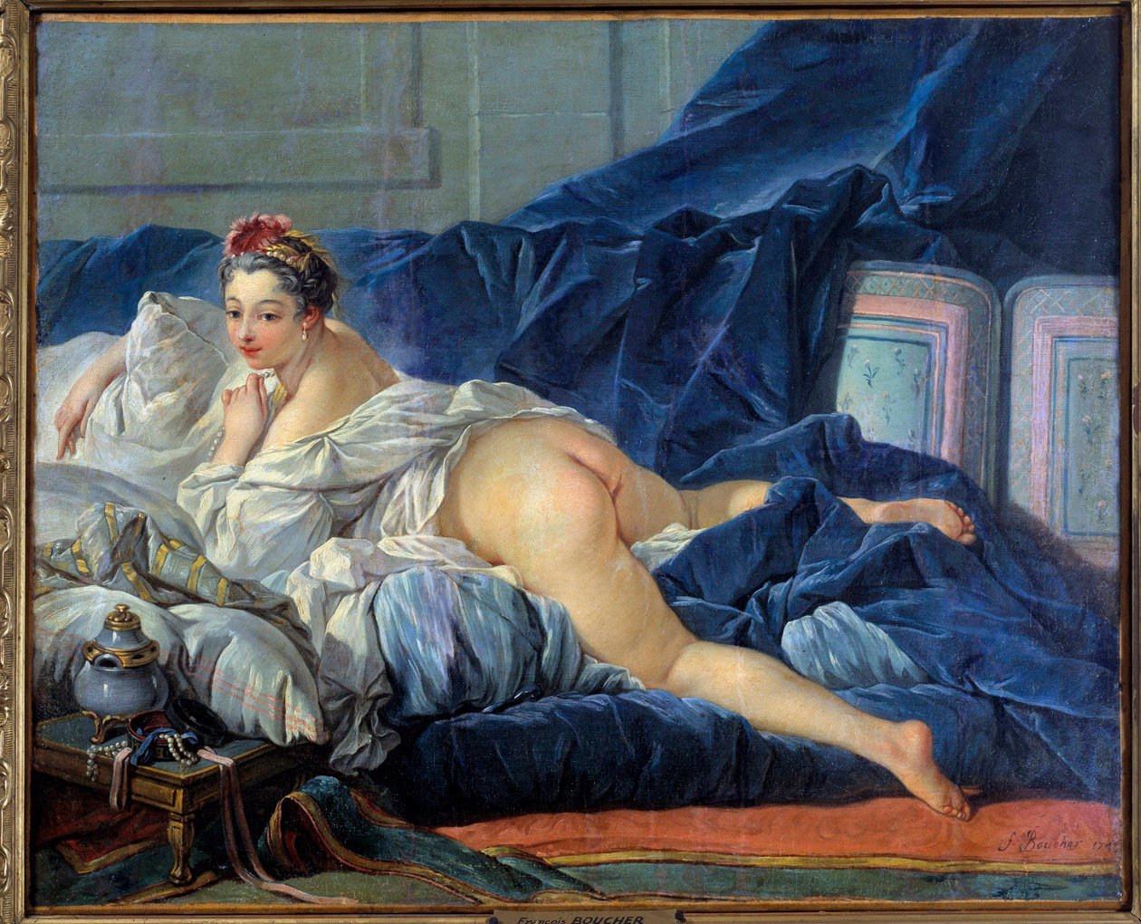 The odalisque Young Woman is sitting on a sofa by François Boucher