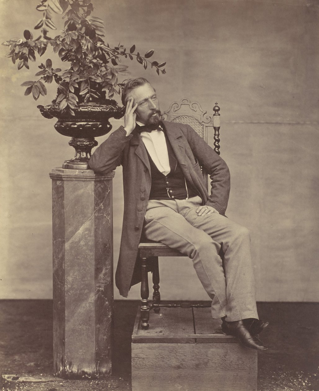 Mathias Höusermann seated with elbow on pedestal holding a vase of flowers by Franz Antoine