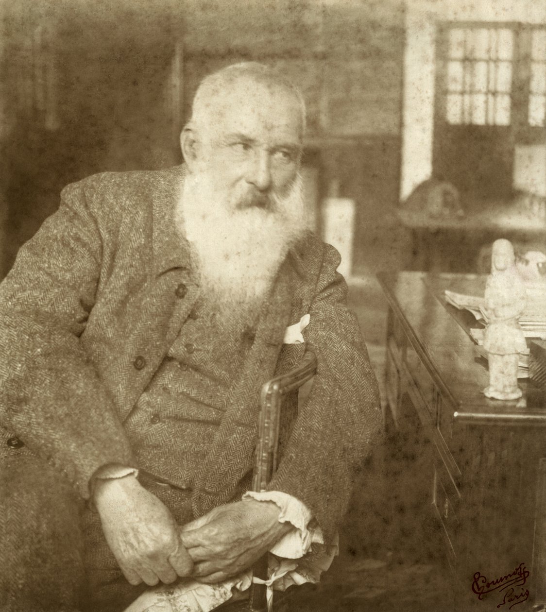 Claude Monet with a Tanagra statuette, early 20th century by French Photographer