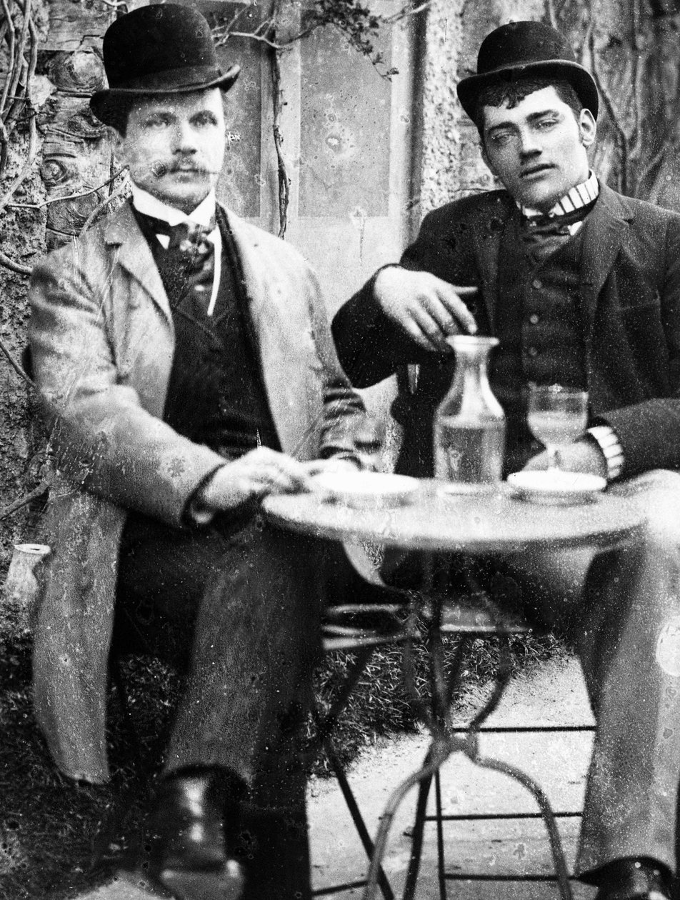 A chatelain (Ducos) and his coachman sitting on the terrace of a café and drinking absinthe - photograph, circa 1890 by French Photographer