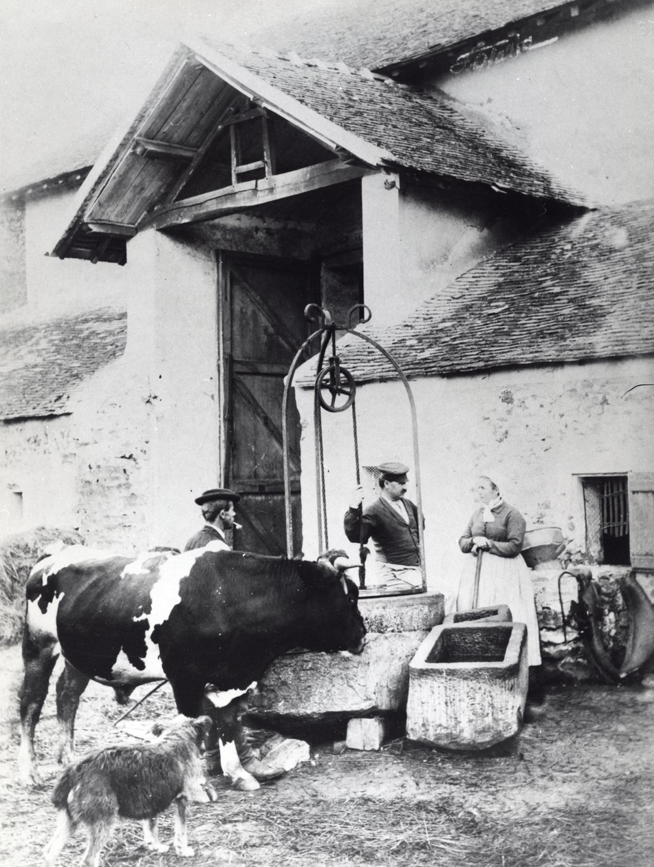 Peasants around a well, in a farmyard by French Photographer