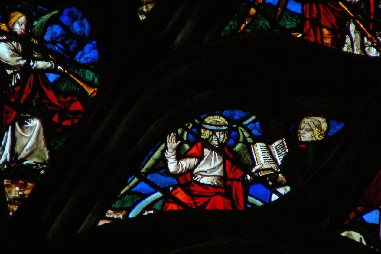 The west rose window depicting a scene from the Book of Revelation: An angel on a rainbow giving St. John an open book by French School