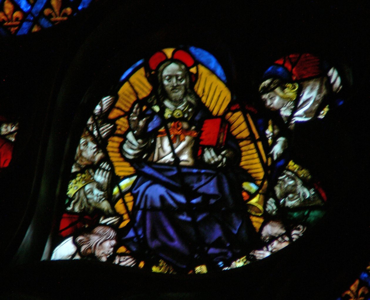 The west rose window depicting a scene from the Book of Revelation: Seventh trumpet; the elders prostrate themselves before the throne by French School
