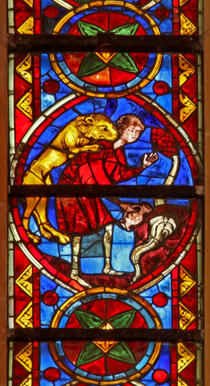 Window w213 depicting a scene from the life of St Thomas: a lion attacks the cupbearer as he collects water and removes his arm by French School