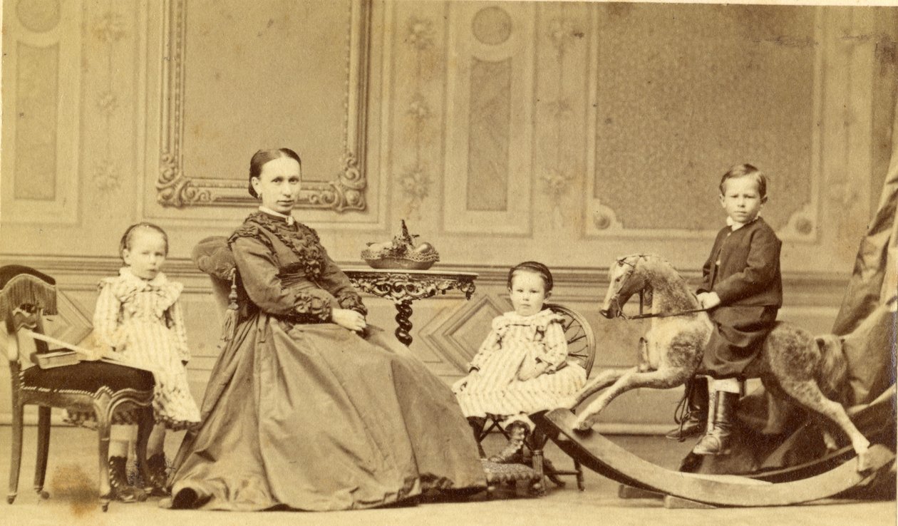 Young boy on rocking horse surrounded by his family by Georg Friedrich Brandseph