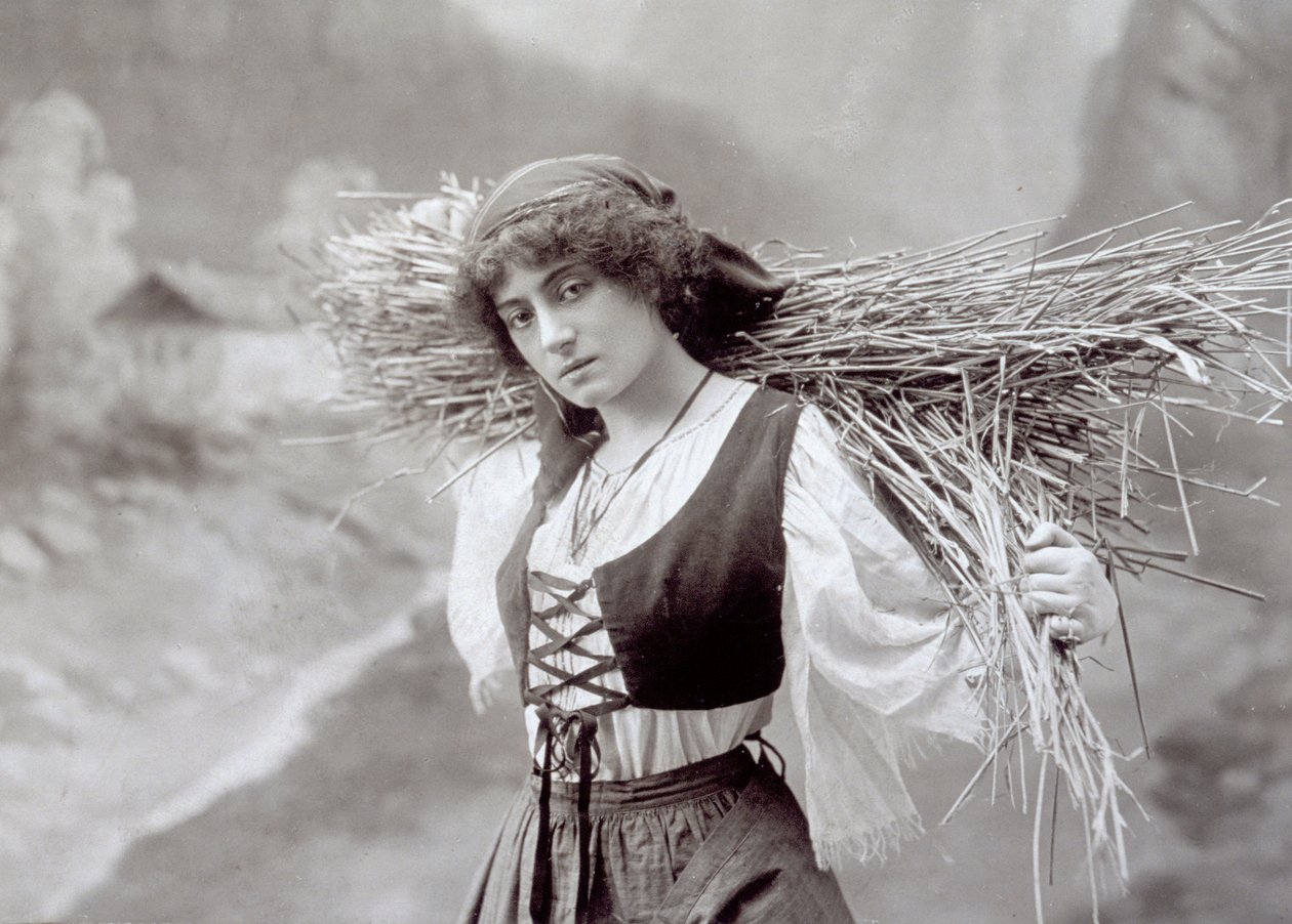 Young woman in traditional dress carrying a bundle of straw by Giacomo Brogi