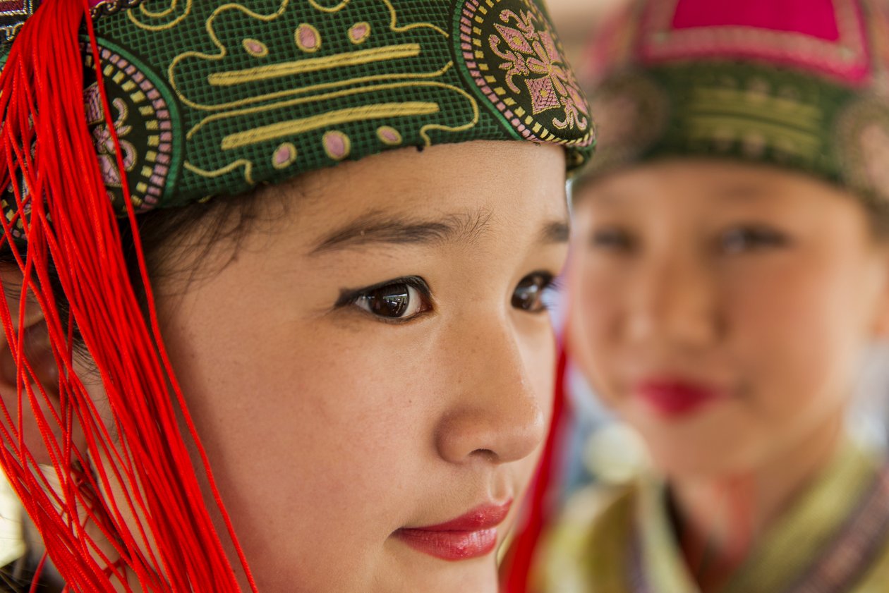 Portrait of a young girl wearing Deel, Mongolian traditional clothing at Naadam by Ira Block