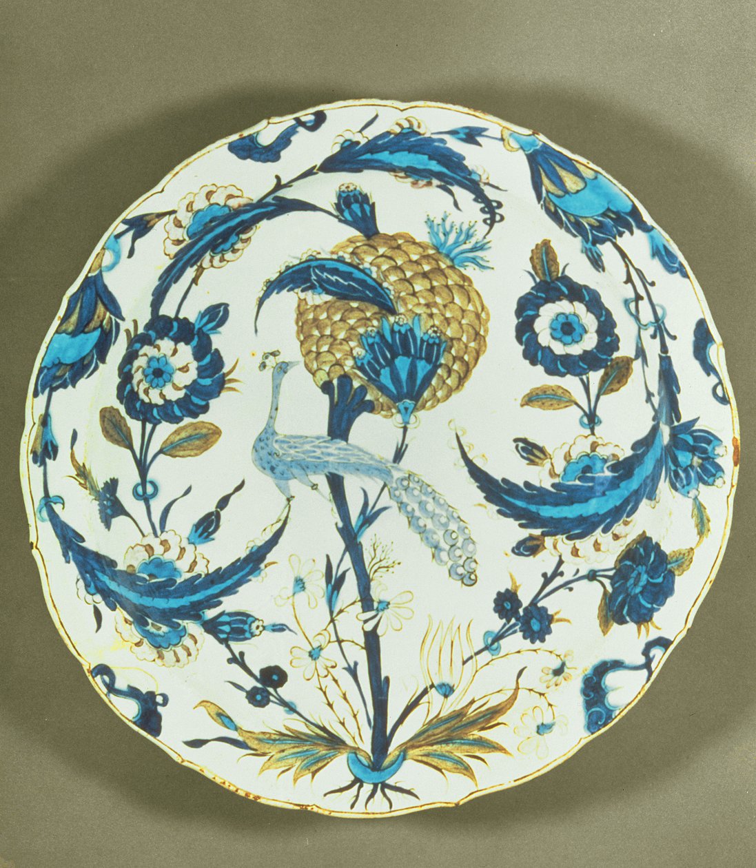 Iznik dish painted with a peacock perched among flowers, Turkey, c.1550-55 by Islamic School